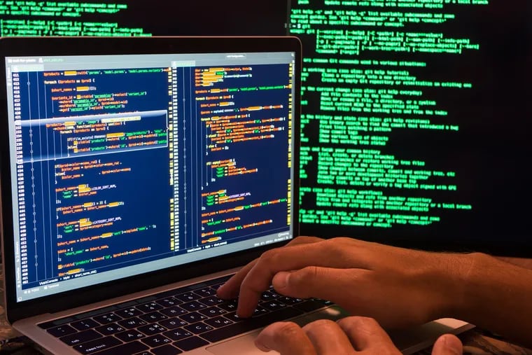 Stock image shows a hacker breaching the secure system in cyberspace, hands on keyboard.