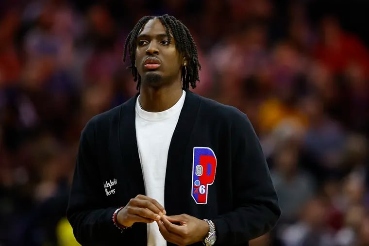 Injured Sixers guard Tyrese Maxey stands on the sidelines during a break against the Charlotte Hornets on Sunday, December 11, 2022 in Philadelphia.