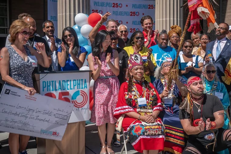 Grant recipients and others gather for a photograph at Smith playground in Philadelphia after the Tuesday, June 28, 2022 announcement of the 11 semi-finalist organizations that will receive $11,000 "Leave a Legacy" grants from Philadelphia 250.