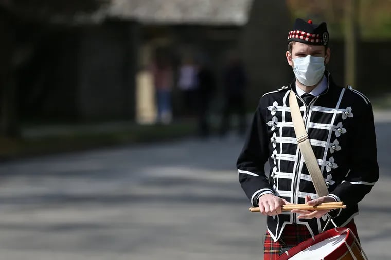 In Philadelphia's Chestnut Hill neighborhood, Church of St. Martin-in-the-Fields organized a socially distanced Easter parade with two bagpipe players and a drummer to perform traditional Easter hymns on Sunday. Drummer Corey Purcell, of Allentown, pauses along Willow Grove Avenue.