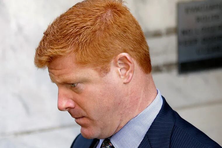 Former Penn State assistant football coach Mike McQueary leaves the Dauphin County Courthouse in Harrisburg on Monday.