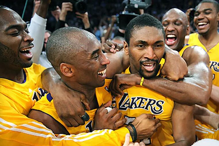 Ron Artest, center, is congratulated by teammates after hitting the winning basket. (AP Photo/Los Angeles Times, Wally Skalij)