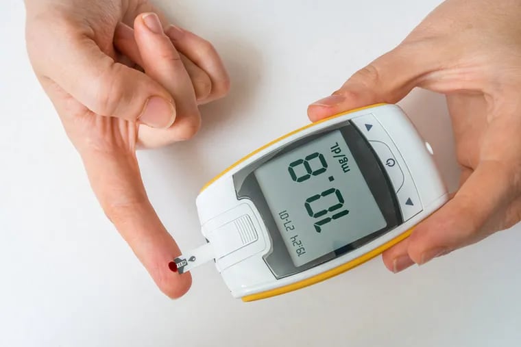 Diabetic patient is monitoring glucose level from blood from finger.