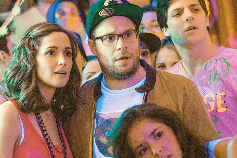 This image released by Universal Pictures shows Rose Byrne, left, and Seth Rogen in a scene from "Neighbors." (AP Photo/Universal Pictures, Glen Wilson)
