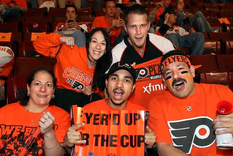 Cheering the Flyers before Game 6 (above from left), Gerri Prusacki, Karen Prusacki, Mike Graziano Jr., Kevin Myers and Mike Graziano Sr. At right, Judi Simmons and boyfriend Kurt Shuman, wearing their ripe Flyers jerseys, can smell victory before the game.