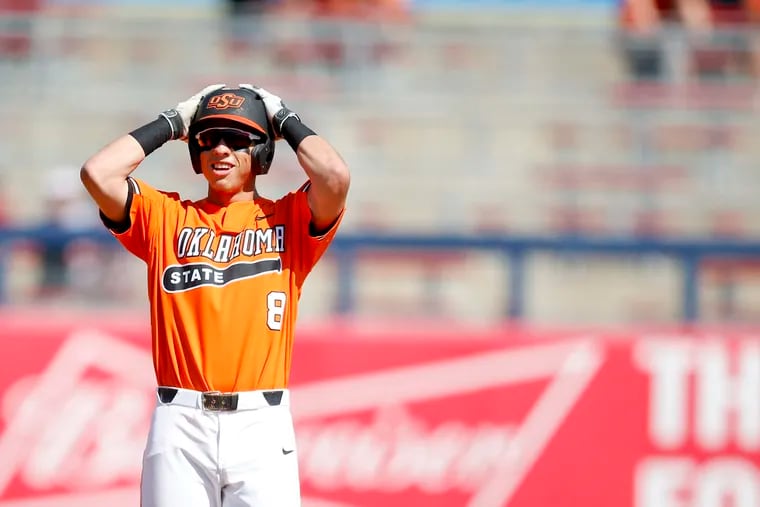 Oklahoma State third baseman Matt Kroon (8) celebrates towards his dugout after hitting a double during the college baseball game between Oklahoma State and Oklahoma at ONEOK Field in Tulsa, Okla. on Sunday, April 29, 2018 