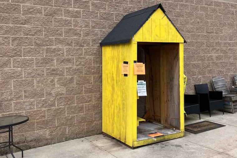 The yellow shelter that once protected the community fridge from the elements sits empty in front of Weavers Way in Ambler.