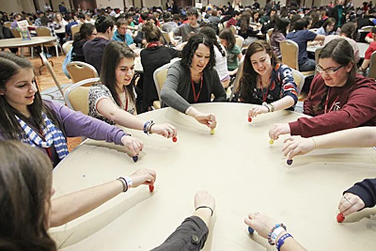 Table 77 takes its last spin at the world record attempt with the other participants. Approximately 900 youths participated in the attempt to break the Guinness book of world record for dreidels spun simultaneously in the same room. (Alejandro A. Alvarez / Staff Photographer)