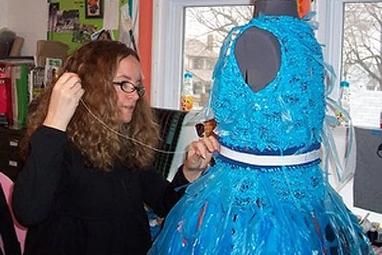 Cathy Kasdan sews a blue plastic ensemble. Kasdan, pursuing a master's degree in textile design at Kent State University, turned more than 400 plastic grocery bags into workable yarn. (Photo from Avid Kasdan)