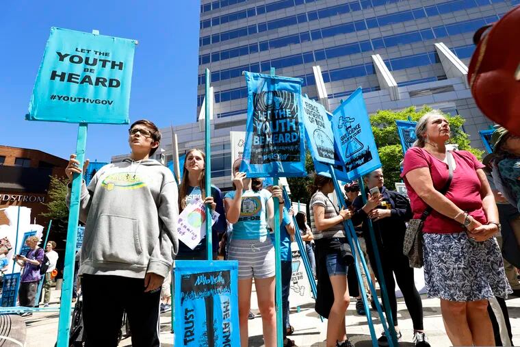Supporters attend a rally Tuesday, June 4, 2019 for a group of young people who filed a lawsuit saying U.S. energy policies are causing climate change and hurting their future. The group faces a major hurdle Tuesday as lawyers for the Trump administration argue to stop the case from moving forward. in Portland, Ore. (AP Photo/Steve Dipaola)