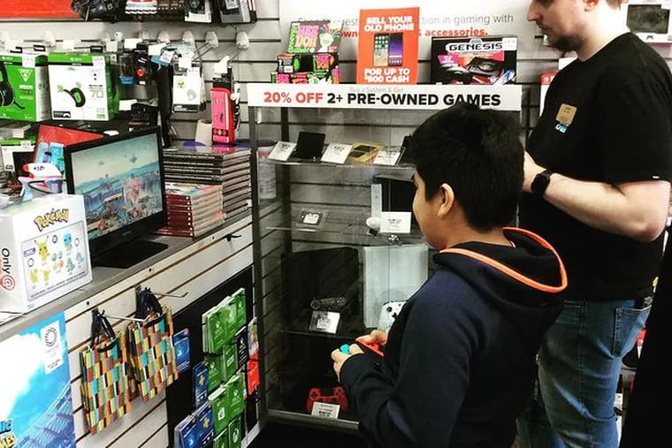 Gaming customers at GameStop shop at the Cherry Hill Shopping Center location. The store is the third-largest in the company by sales.