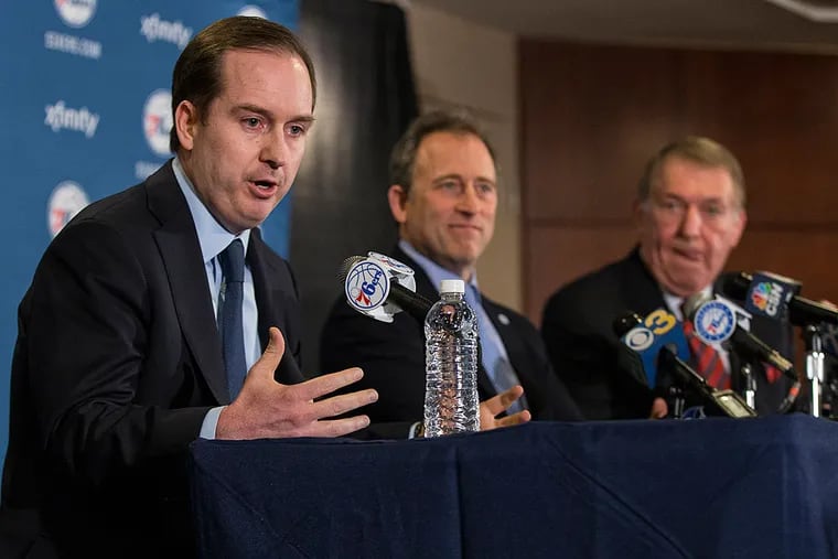 Philadelphia 76ers general manger Sam Hinkie, left, takes question from the media as the announce that Naismith Memorial Basketball Hall
of Fame member and Chairman of the Board of Directors for USA Basketball Jerry Colangelo, right, talks to the media as he will be joining the Philadelphia 76ers as the Special Advisor to the Managing General Partner and Chairman of Basketball Operations and co-Managing Owner Josh Harris, center, beside him prior to the first half of an NBA basketball game against the San Antonio Spurs, Monday, Dec. 7,
2015, in Philadelphia.