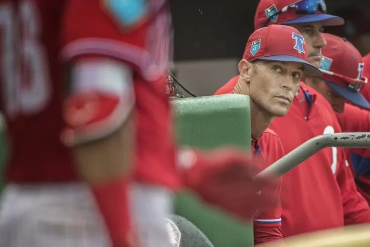 Phillies manager Gabe Kapler, center, keeps his eyes on Phillies right fielder, Jesmuel Valentin, left, as he gets ready to bat against the Toronto Blue Jays on March 20, 2018, during a spring training game.