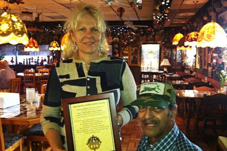 pWAR12.  Photo by Barbara Boyer
Krystyna Wittmann, owner of Sebastian's Schnitzel Haus in Wrightsville, with Air Force veteran Mohammed Didin of Pemberton. Wittmann displays an honorary recognition she received from a commander at Joint Base McGuire-Dix in Burlington County.