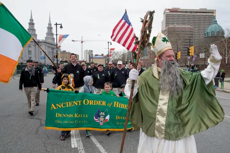 John Cooke, dressed at St. Patrick, leads members of the Ancient Order of Hibernians Div. 1 Dennis Kelly out of Havertown around Logan Circle and up the Ben Franklin Parkway during Philadelphia's annual St. Patrick's Day Parade March 13, 2016.   CLEM MURRAY / Staff Photographer