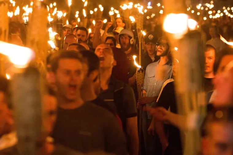 Neo-Nazis, alt-Right, and white supremacists march the night before the "Unite the Right" rally in Charlottesville, Va., in 2017. The rising threat of violent white supremacist extremism prompted the state of New Jersey to call the threat "high," a rating above jihadist groups Al Qaeda and ISIS.