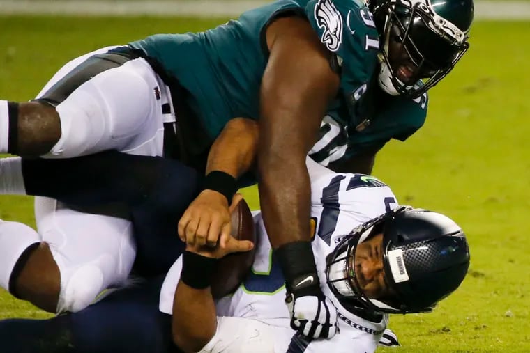 Fletcher Cox, shown sacking Russell Wilson Monday night, has missed practice the last two days with a neck problem.