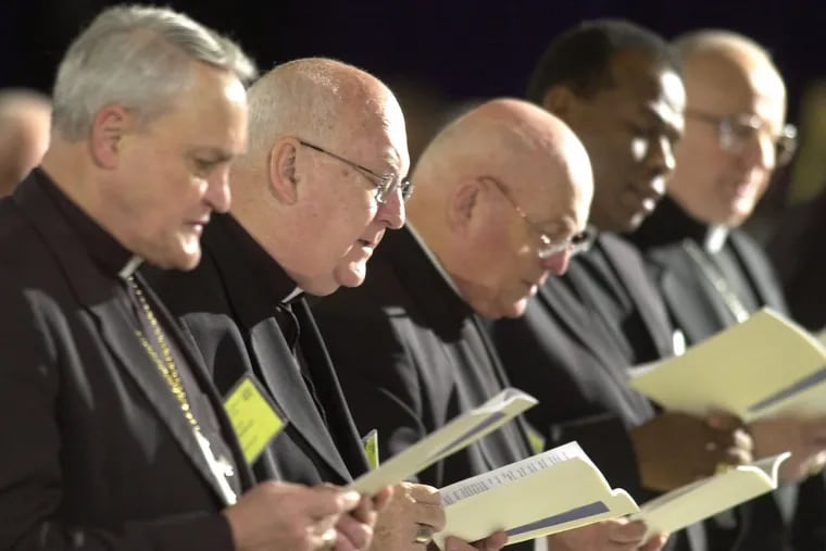 Bishops sing a hymn during the opening of Friday morning session at the U.S. Conference of Catholic Bishops' meeting in Dallas, Friday, June 14. 2002. (AP Photo/Charlie Riedel)