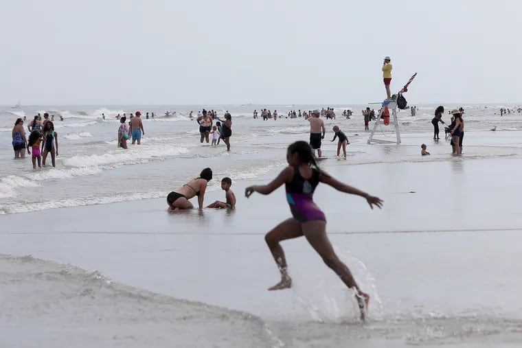 People enjoy the water at the beach in Wildwood earlier this month, one of the hotter Julys on record. The Shore has been a big draw, and ironically the oceans are adding to the discomfort.