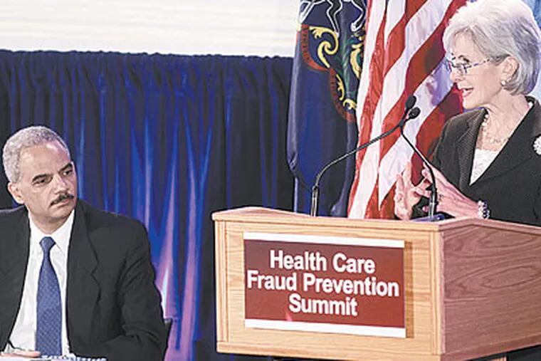Kathleen Sebelius, Secretary of Health and Human Services delivers keynote remarks while U.S. Attorney General Eric Holder listens Friday at the Philadelphia Health Care Fraud Prevention Summit held at University of the Sciences. (Alejandro A. Alvarez / Staff Photographer)