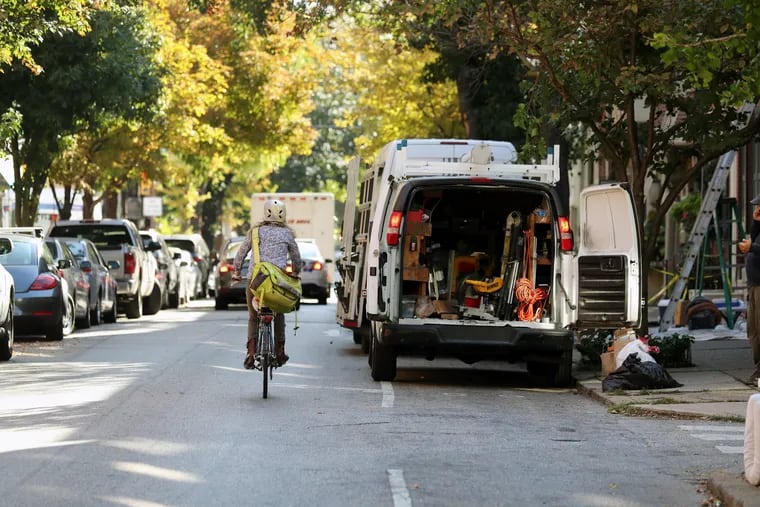Because bike lanes are often blocked by delivery vans, building contractors, ride-hailing vehicles and resident parking, bicyclists must weave in and out of traffic. Here, Pine Street, between 18th and 22nd, is blocked by a contractor.