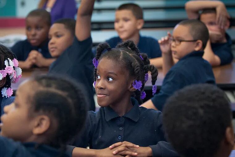 Second grader Mia Johnson listens attentively during a question-and-answer session at McKinley Elementary School. (TRACIE VAN AUKEN/For The Inquirer)