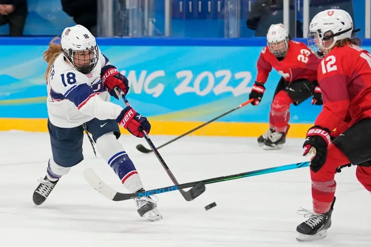 Jesse Compher (left) fires in a goal during the U.S. women's hockey team's 8-0 rout of Switzerland.
