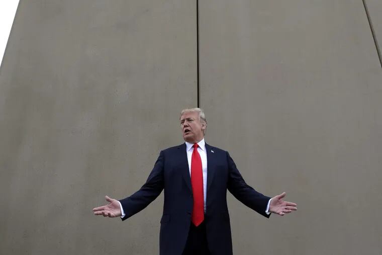 In this March 13, 2018 photo, President Trump speaks during a tour as he reviews border wall prototypes in San Diego.