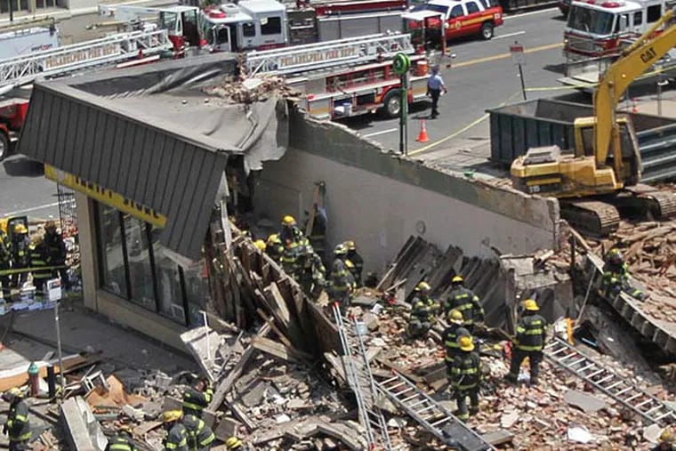 The disaster scene at 22nd and Market, where six people died when a wall collapsed onto a thrift store June 5, 2013. A design for a memorial at the site won Philadelphia Art Commission approval this week. (MICHAEL BRYANT / Staff Photographer)