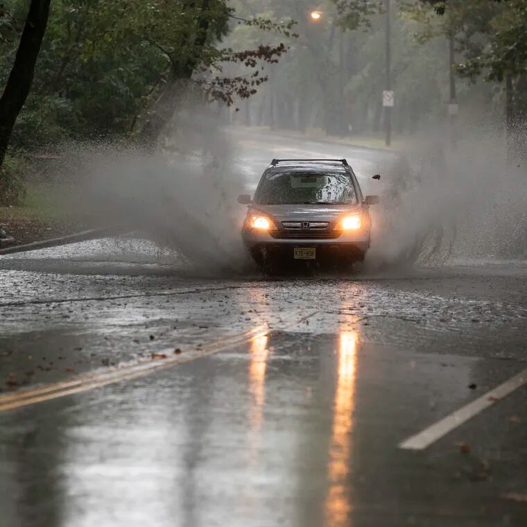 Cars drive through high water along Martin Luther King Jr. Drive in Philly in September. Heavy rains are possible this weekend.