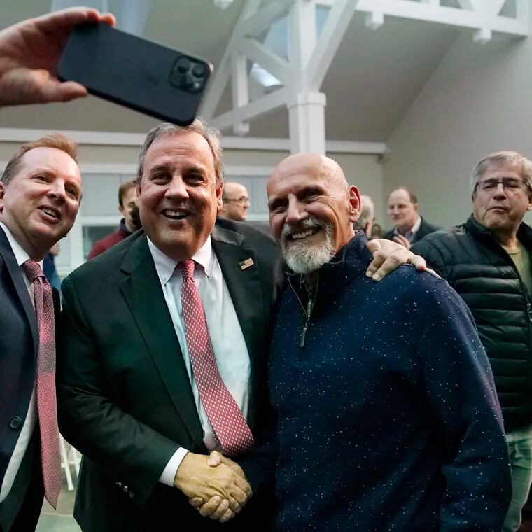 Former New Jersey Gov. Chris Christie (center) poses for a selfie after a town hall-style meeting at New England College on April 20 in Henniker, N.H. He's expected to officially launch his campaign on Tuesday.