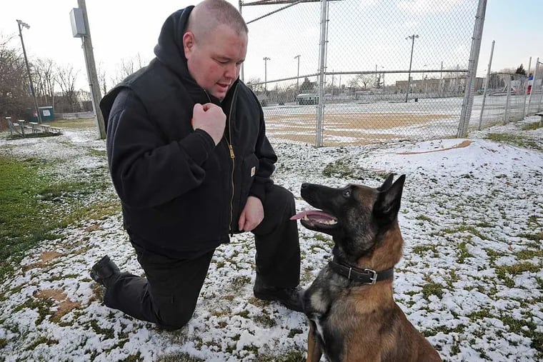 Officer Gene Mackey and his dog, Sarge, in Folcroft in 2013. "We were there so fast, they didn't have time to meet us with a stretcher," he said of Saturday's gun accident involving a 10-year-old. (APRIL SAUL / File photo)