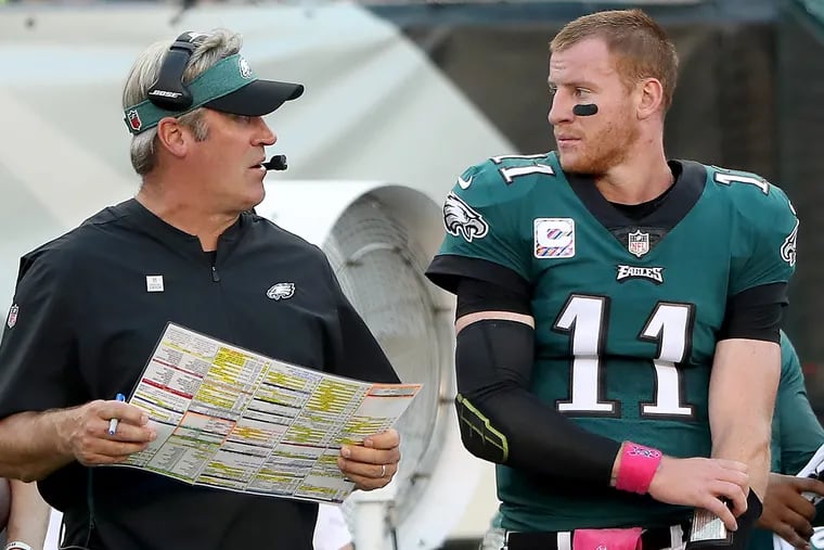 Eagles head coach Doug Pederson, left, and Carson Wentz, right, talk after Wentz fumbled the ball and the Vikings scored on the 2nd quarter play. The Philadelphia Eagles lose 23-21 to the Minnesota Vikings in Philadelphia, PA on October 7, 2018. DAVID MAIALETTI / Staff Photographer