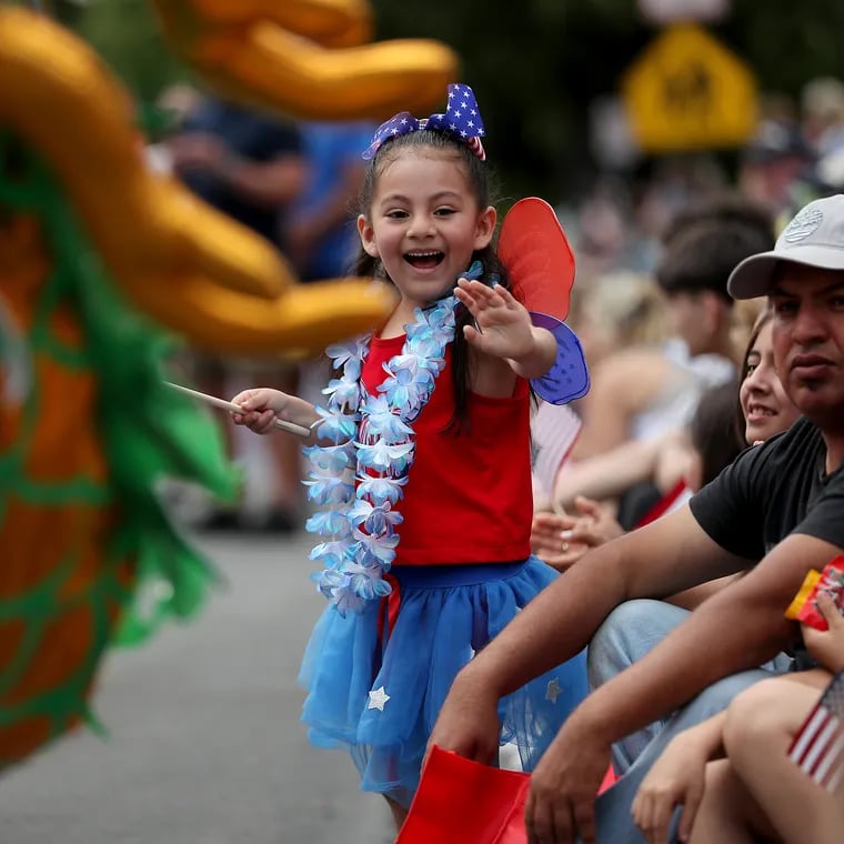 Aylin Gomez, 5, of Kennett Square, waves at participants in the Kennett Square Memorial Day Parade in Kennett Square, Pa. on Monday, May 29, 2023. 