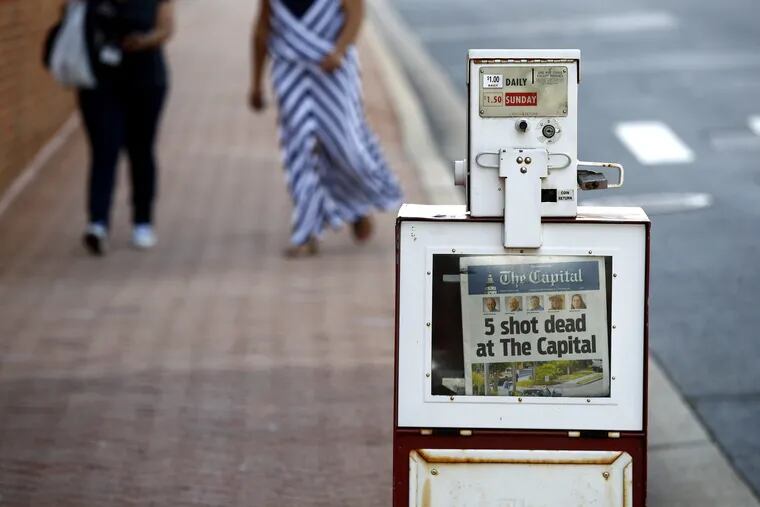 A Capital Gazette newspaper rack displays the day's front page, Friday, June 29, 2018, in Annapolis, Md. A man armed with smoke grenades and a shotgun attacked journalists in the newspaper's building Thursday, killing several people before police quickly stormed the building and arrested him, police and witnesses said.