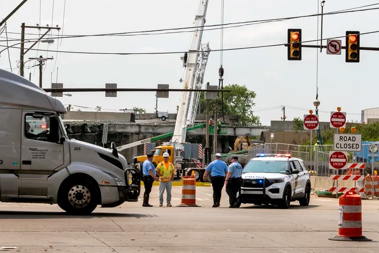 Detoured commercial truck traffic and other drivers pass on the one-way-only, southbound State Road on Thursday. The road was closed Friday morning due to down wires.