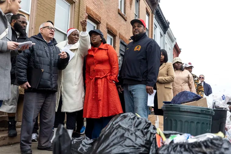 Bonita Cummings, head of Strawberry Mansion Community Concern, points out illegal dumping to Mayor Cherelle L. Parker during a tour of Strawberry Mansion earlier this year. At right is Carlton Williams, Parker's director of clean and green initiatives.