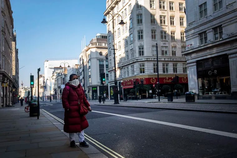 A woman walks down the Strand during "rush hour" in Westminster, London, on Thursday.