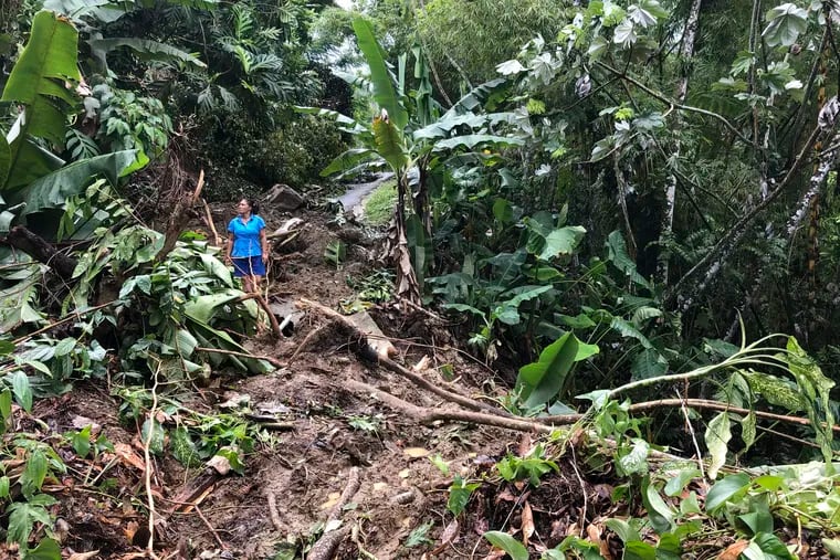 Nancy Galarza looks at the damage that Hurricane Fiona inflicted on the rural community of San Salvador in the town of Caguas, Puerto Rico, on Thursday.