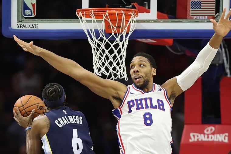Jahlil Okafor forces the Grizzlies’ Mario Chalmers to miss a shot.