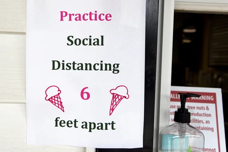 A six-feet social distancing sign posted at take-out window of Springer's Homemade Ice Cream in Stone harbor May 19, 2020.