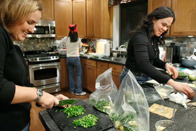 Warm friendship and frozen family fare with flair top the menu when (from left) Sarah Wagner, Rhea Lee and Susanna Schweikert get together to prepare ready-to-serve meals.