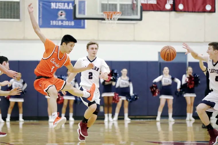 Cherokee’s Justin Kang (No. 1 in orange) battles with Eastern's Andrew Heck (No. 2) and Noah Klinewski (No. 4) for control of the basketball during Thursday's Olympic Conference American Division games. Cherokee won, 64-52.