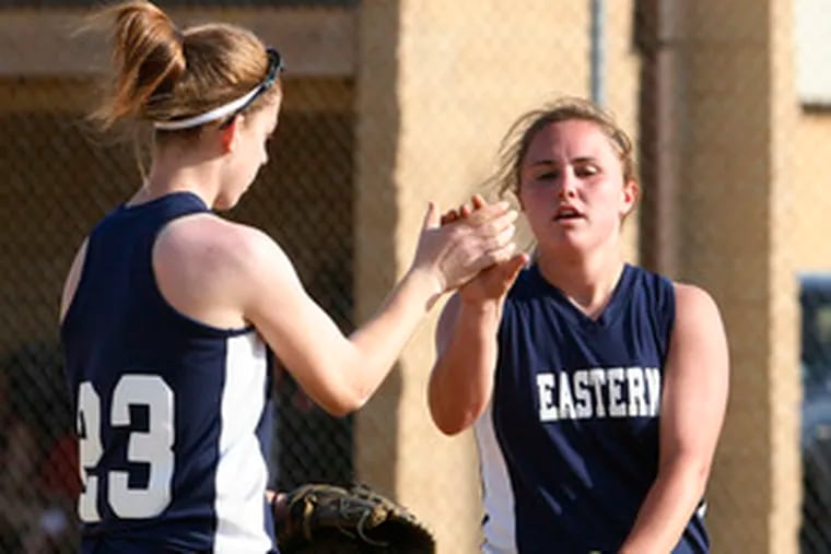 Winning pitcher Brittany Hicks (right) of Eastern is congratulated by teammate Katie Cohen after Monday&#0039;s 9-2 win over Cherry Hill East. Eastern put the game away with a six-run fifth inning.