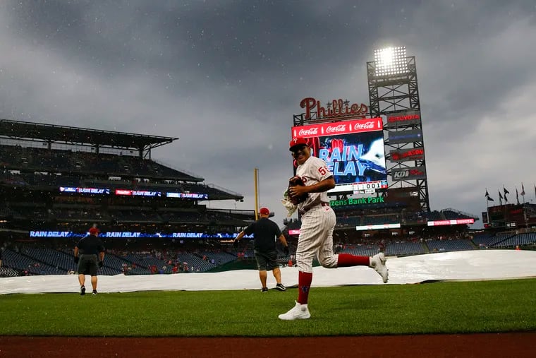 Phillies reliever Ranger Suarez runs to the dugout as rain falls during a delay in the bottom of the fifth inning at Citizens Bank Park.