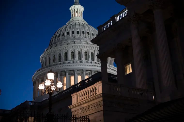The Capitol is seen at day's end as the Senate works on a House-passed bill that would pay for President Trump's border wall and avert a partial government shutdown, at the Capitol in Washington, Friday, Dec. 21, 2018.