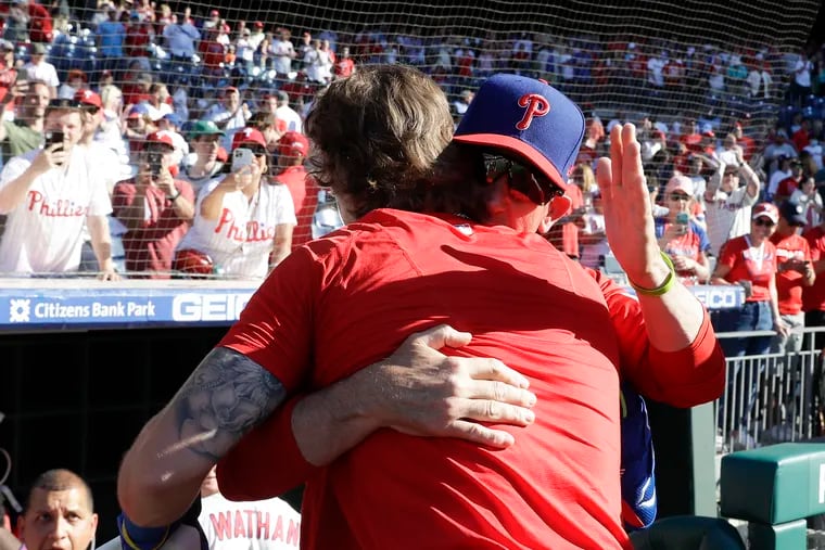 Bryson Stott hugs interim manager Rob Thomson after Stott hit the game-winning three-run homer against the Angels on Sunday.