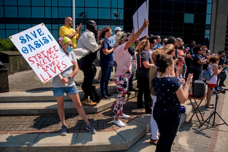 Rachel Sullivan (left) with the Hazel Project in Morris County attends a protest against the Oasis Drop in Center needle exchange in Atlantic City in July.