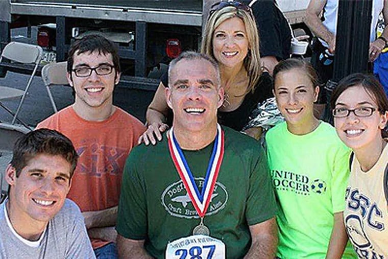 Tim Burke after a Steamtown Marathon with (from left) stepson Jamie Ksiazek, son Michael, wife Susan, daughter Abbey, and Ksiazek’s girlfriend, Michelle Peahota. Burke, who lives near Scranton, was diagnosed with multiple sclerosis in 1998.