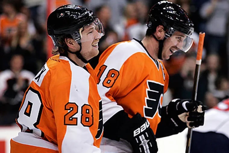 Claude Giroux and Mike Richards each scored two goals against the Panthers Saturday night. (AP Photo/Tom Mihalek)